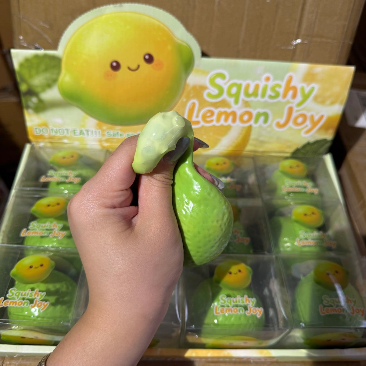 Green lime squishy toy held in hand before changing color